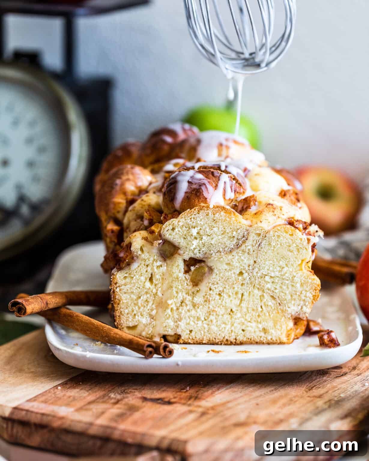 Apple and Pear Bread with whisk drizzling glaze on top