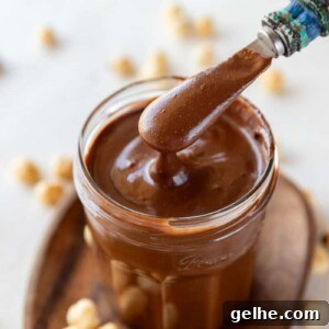 Homemade Nutella chocolate spread in a jar with spoon
