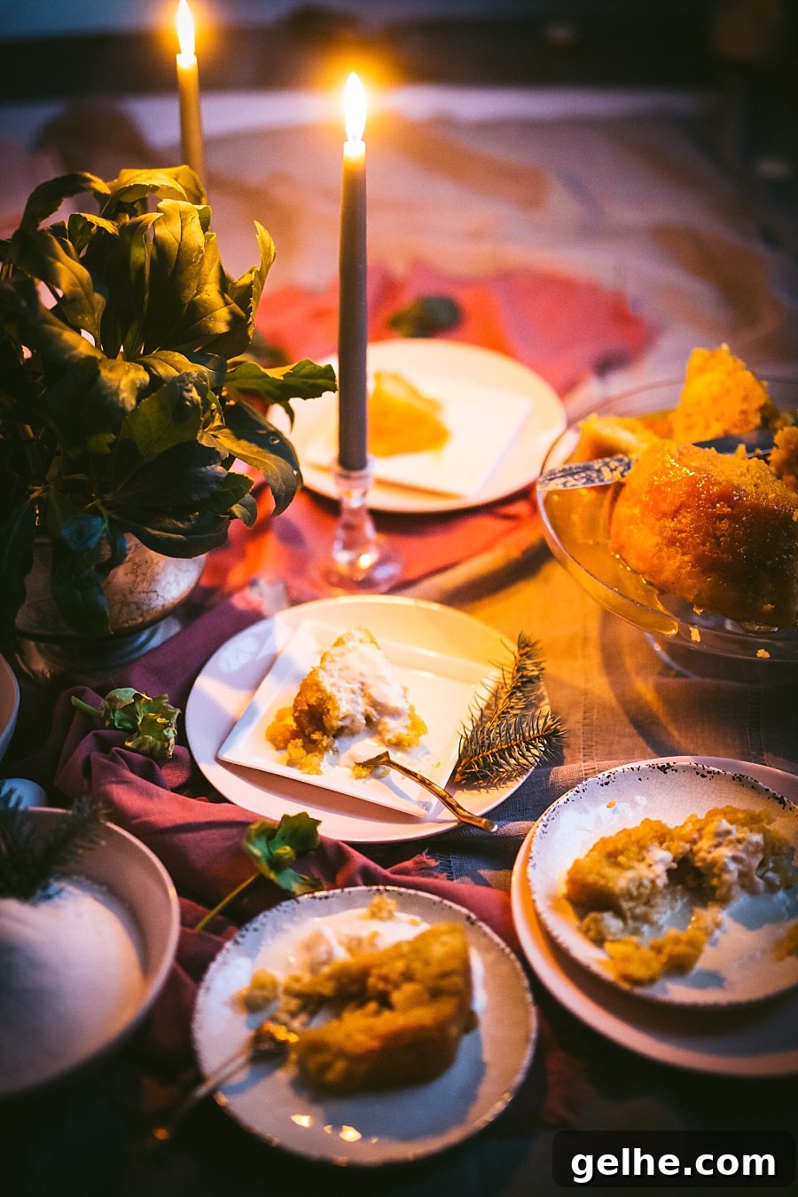 Traditional British Golden Syrup Steamed Sponge Pudding 4 candlelit scene of 4 slices of golden syrup pudding