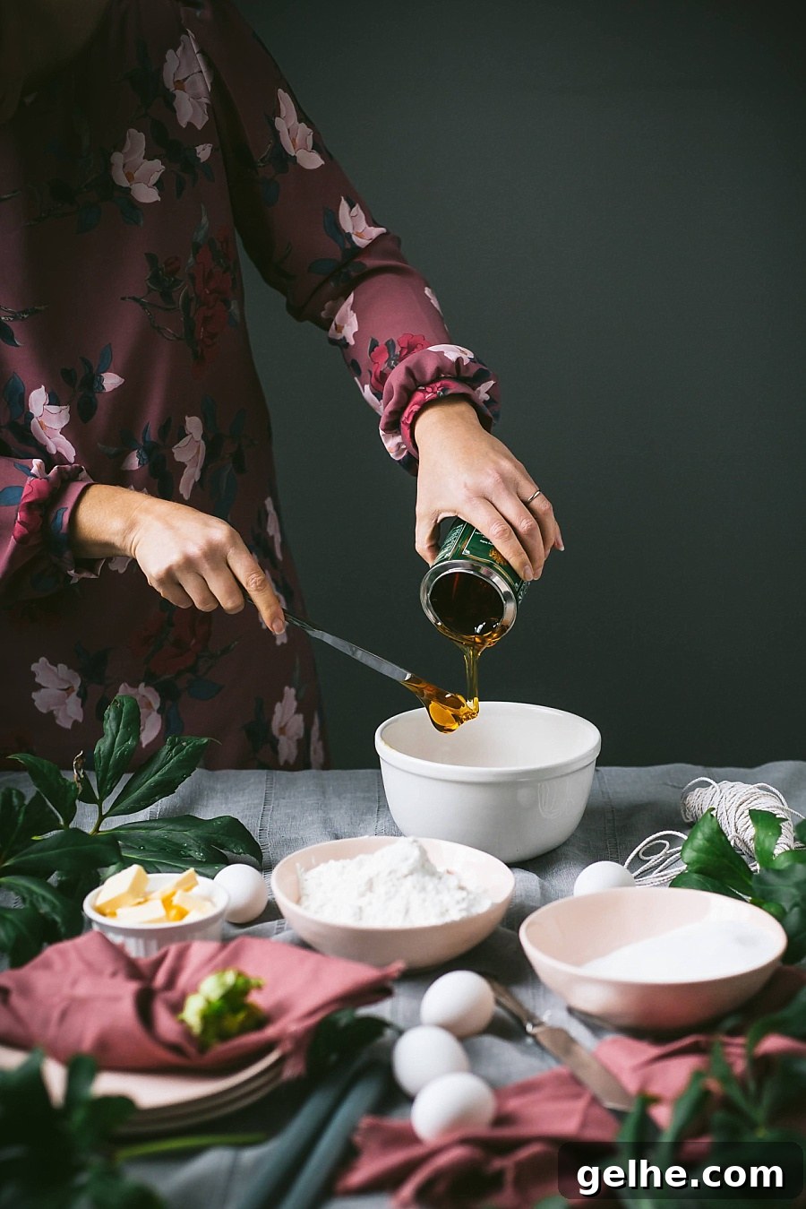 Traditional British Golden Syrup Steamed Sponge Pudding 5 girl in mauve dress spoons lyles golden syrup into bowl in preparation for making golden syrup pudding