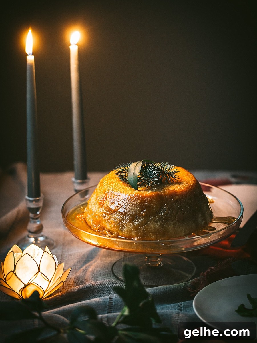 Traditional British Golden Syrup Steamed Sponge Pudding 7 nighttime scene of golden candles next to beautifully steamed pudding covered in golden syrup