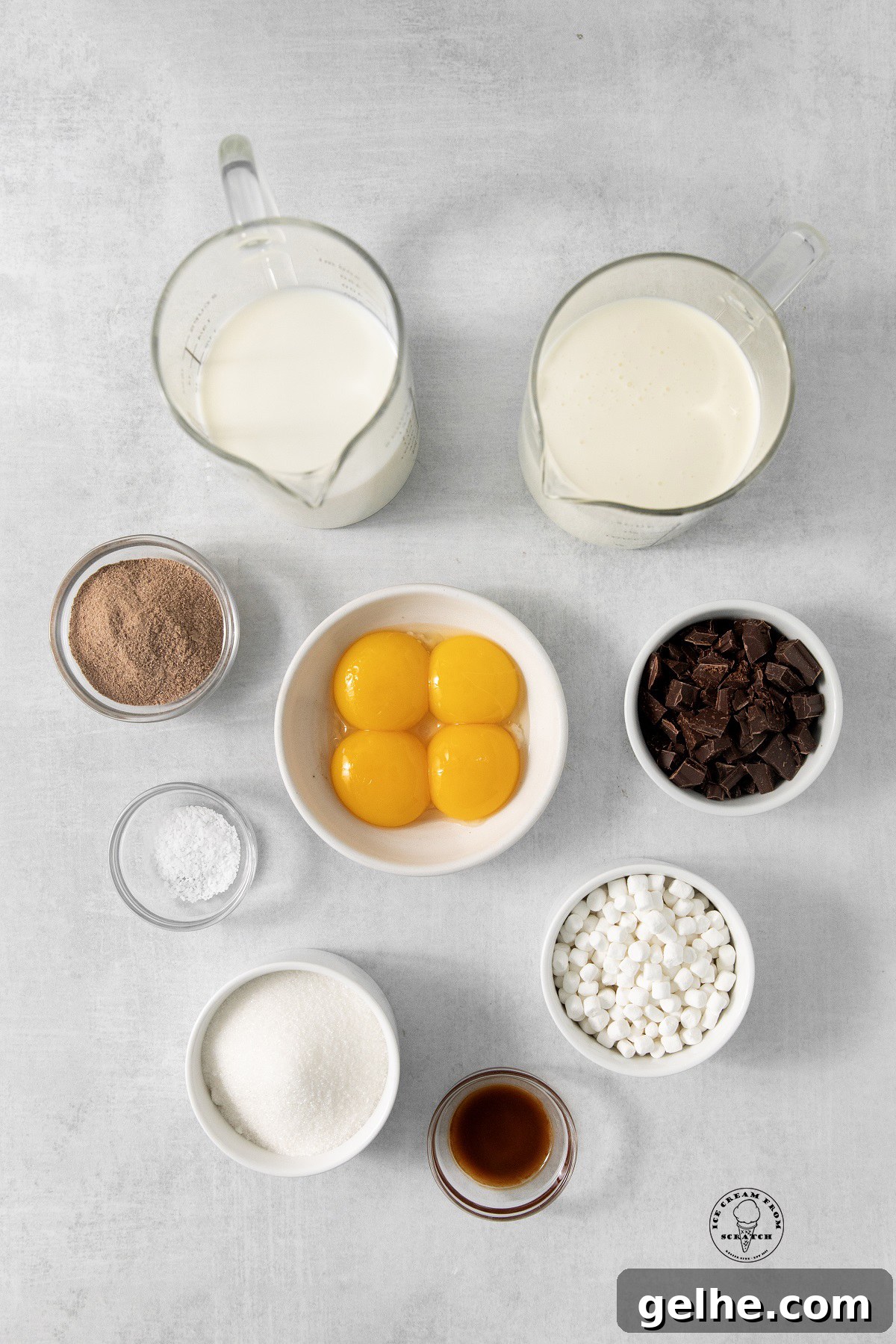 Homemade Hot Chocolate Ice Cream Recipe for Rich, Chocolatey Flavor 3 Ingredients for hot chocolate ice cream, all in separate bowls, arranged on a concrete countertop, viewed from above.