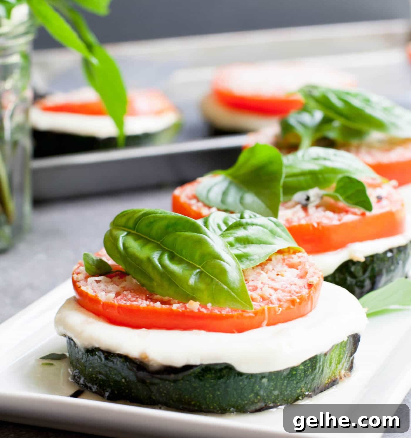 Grilled Zucchini Caprese Stacks. Thick, meaty slices of zucchini are grilled then stacked with hearty slices of tomato and fresh mozzarella. Filling enough for a main, delicious as a side or pop it onto a bun for a delicious veggie sandwich!