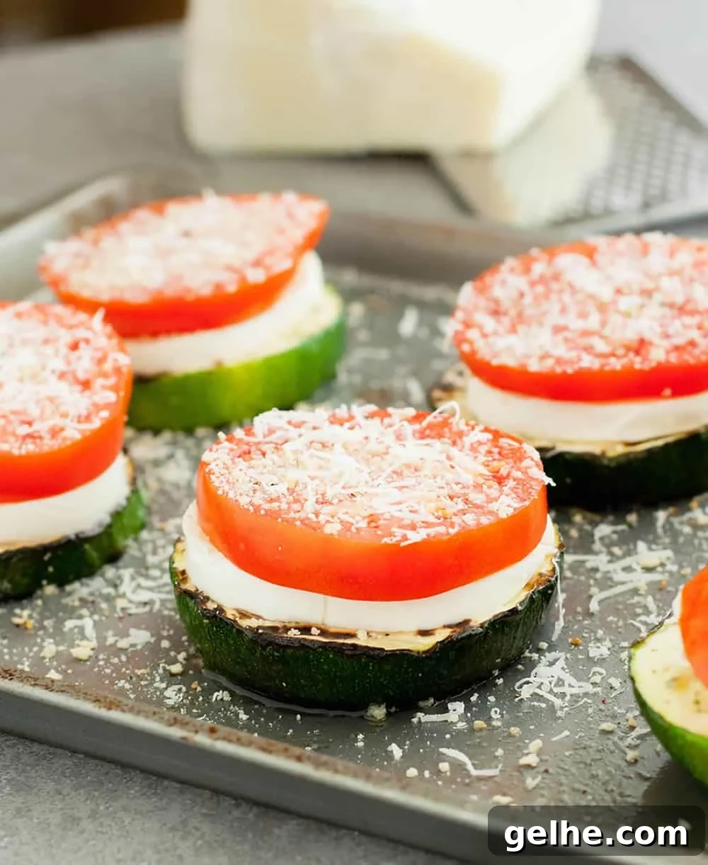 Grilled Zucchini Caprese Stacks. Thick, meaty slices of zucchini are grilled then stacked with hearty slices of tomato and fresh mozzarella. Filling enough for a main, delicious as a side or pop it onto a bun for a delicious veggie sandwich!