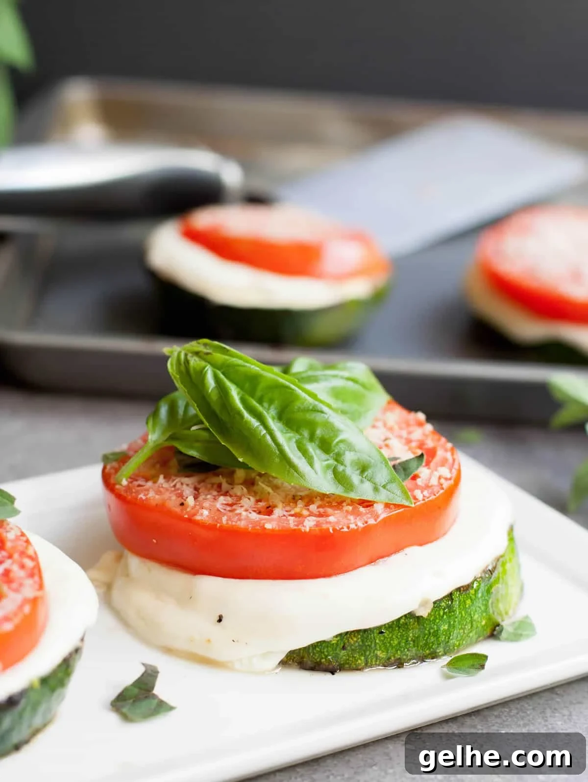 Grilled Zucchini Caprese Stacks. Thick, meaty slices of zucchini are grilled then stacked with hearty slices of tomato and fresh mozzarella. Filling enough for a main, delicious as a side or pop it onto a bun for a delicious veggie sandwich!