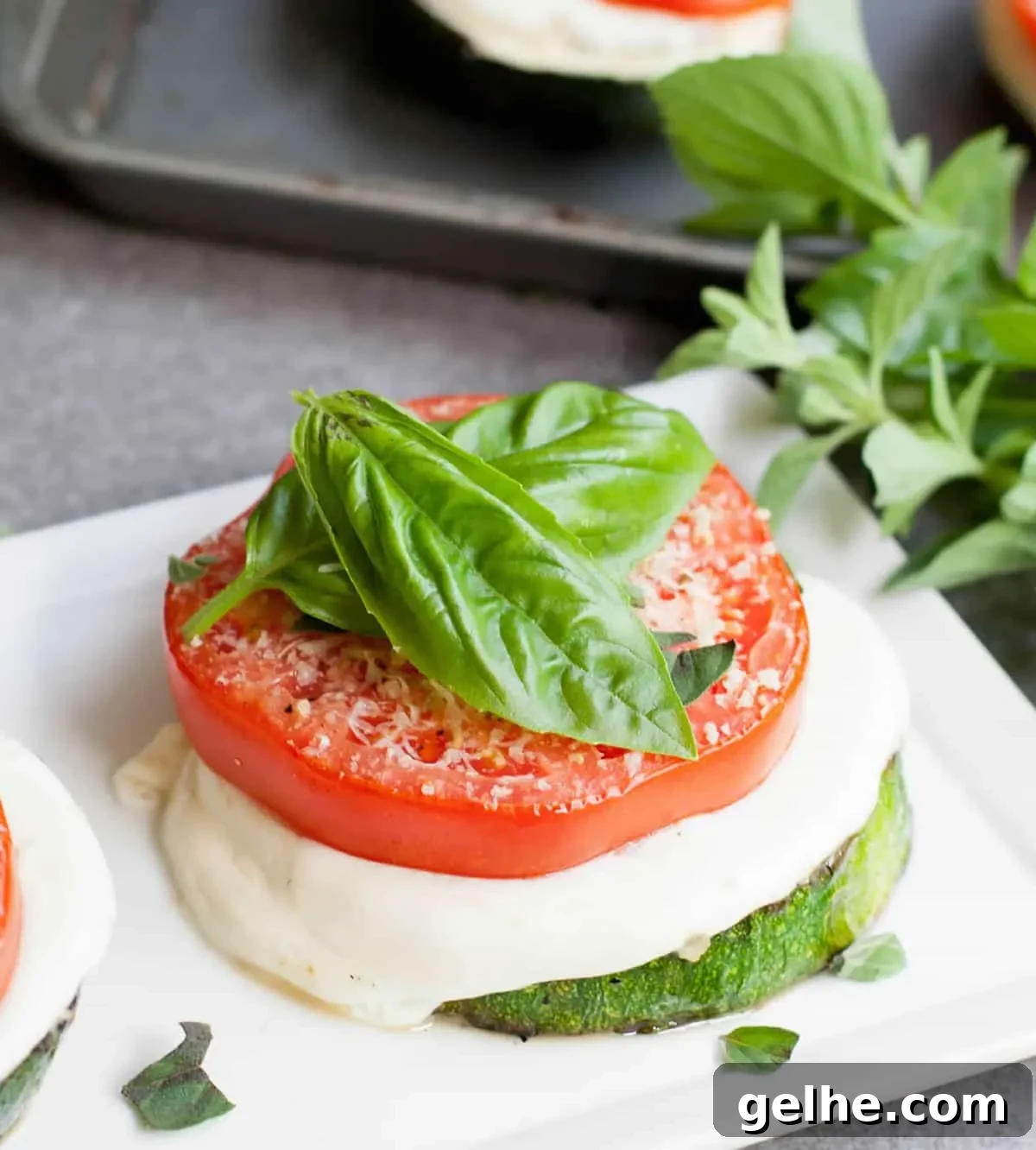 Grilled Zucchini Caprese Stacks. Thick, meaty slices of zucchini are grilled then stacked with hearty slices of tomato and fresh mozzarella. Filling enough for a main, delicious as a side or pop it onto a bun for a delicious veggie sandwich!