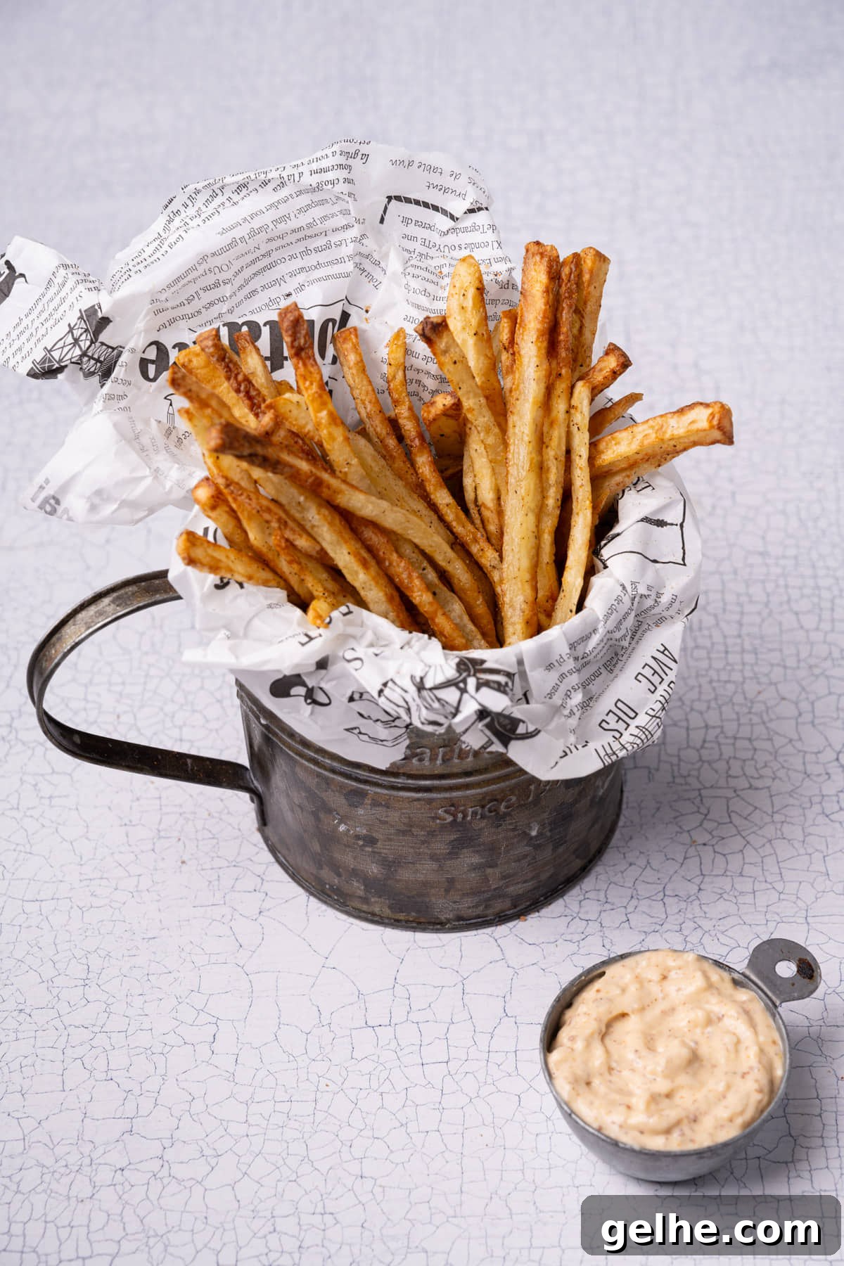 Crispy Cajun Fries: Oven or Air Fryer Recipe for Perfect Seasoning 8 Bucket of homemade Cajun fries served up with a creamy Cajun remoulade.