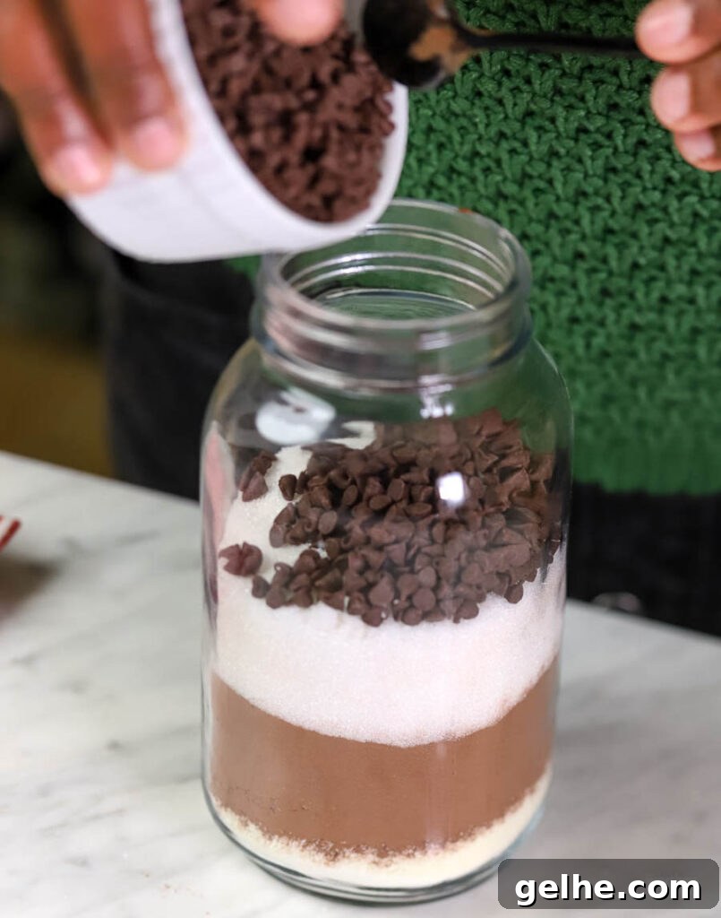 woman putting together a hot cocoa mix in a jar