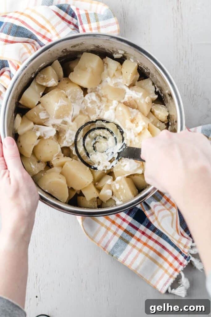 Instant Pot Mashed Potatoes in 20 Minutes 4 Using a potato masher to mash the potatoes directly in the instant pot.