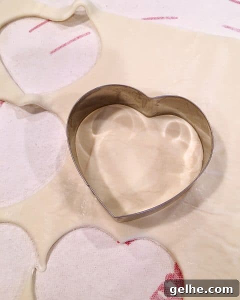 Puff Pastry Sheet with a heart shape cookie cutter cutting out the dough