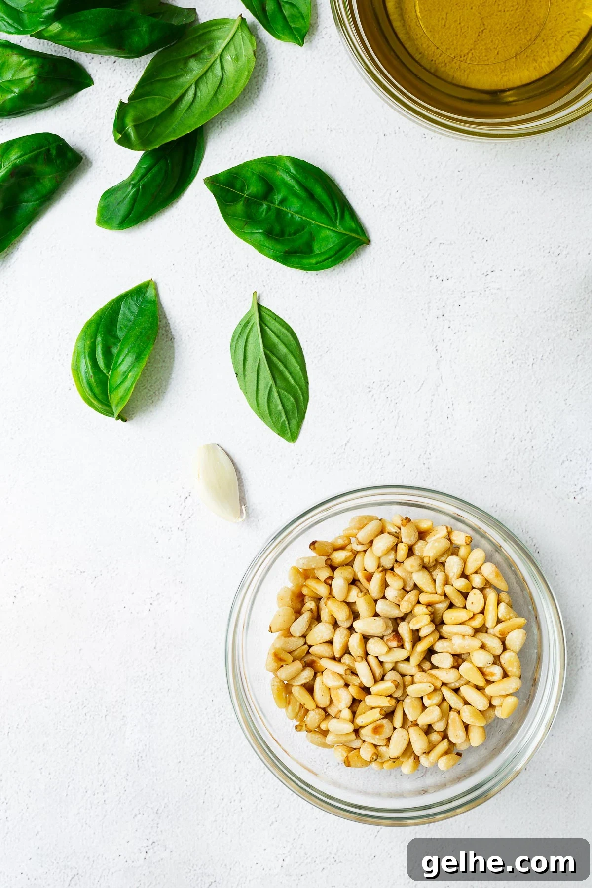 Top down view of pine nuts and basil pesto ingredients.