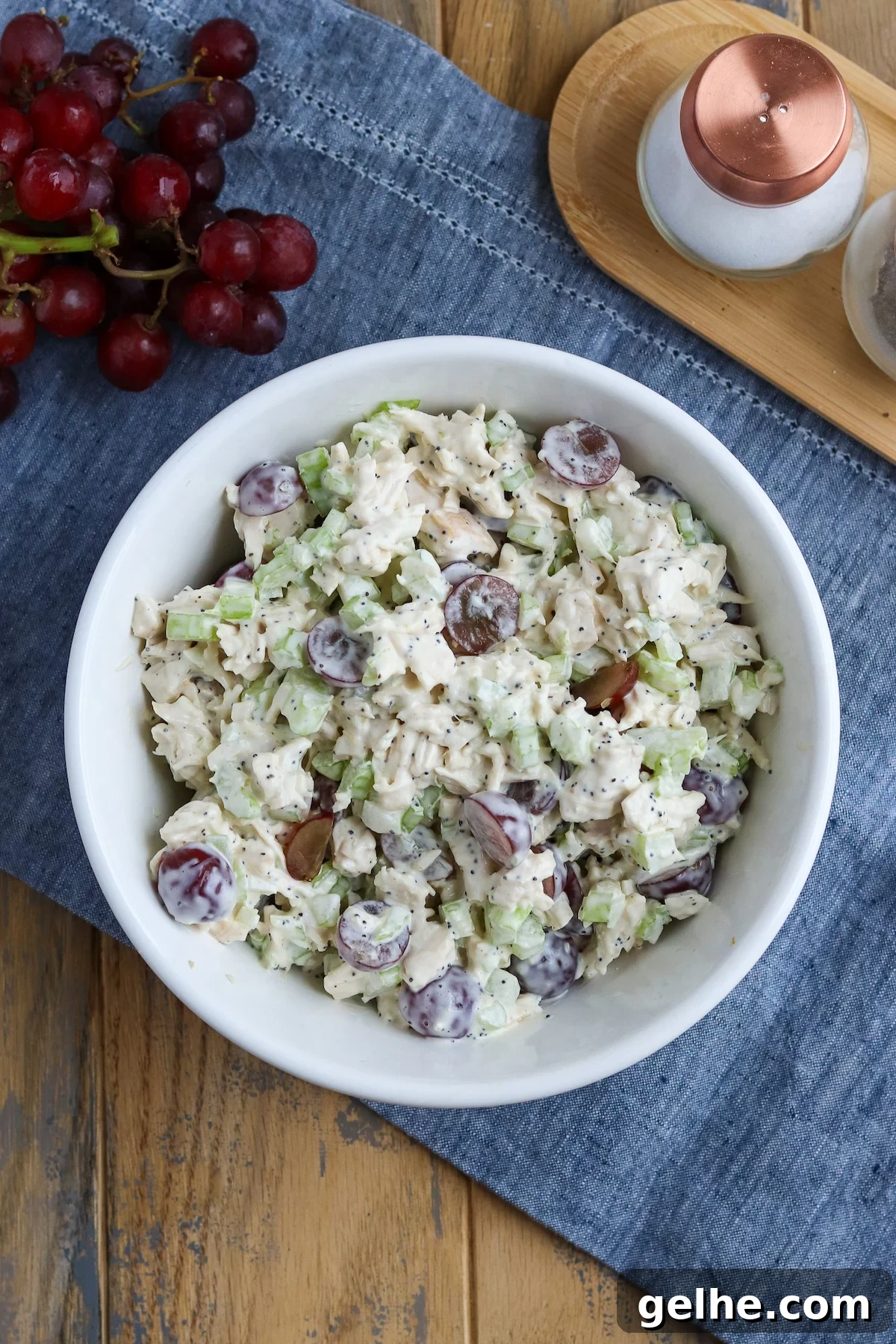 large bowl of prepared chicken salad with poppyseed dressing and grapes and celery
