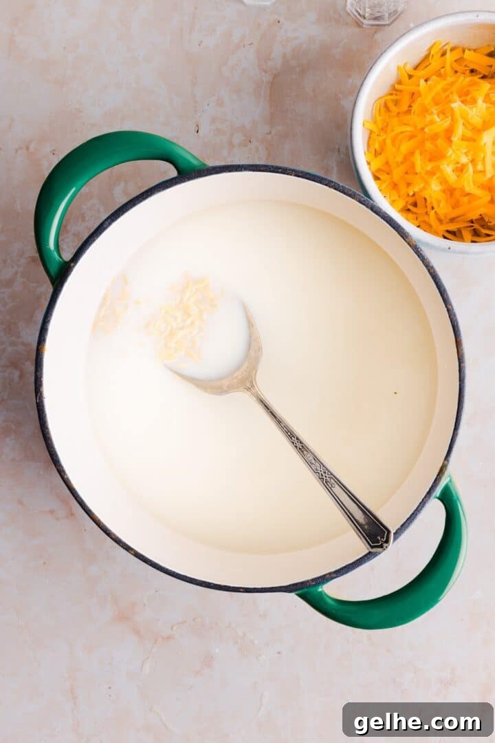 Creamy One-Pot Orzo with Cheese 5 Milk, orzo, and broth added to a large pot, uncooked