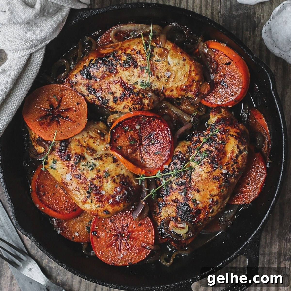 Harissa and persimmon chicken in cast iron skillet.