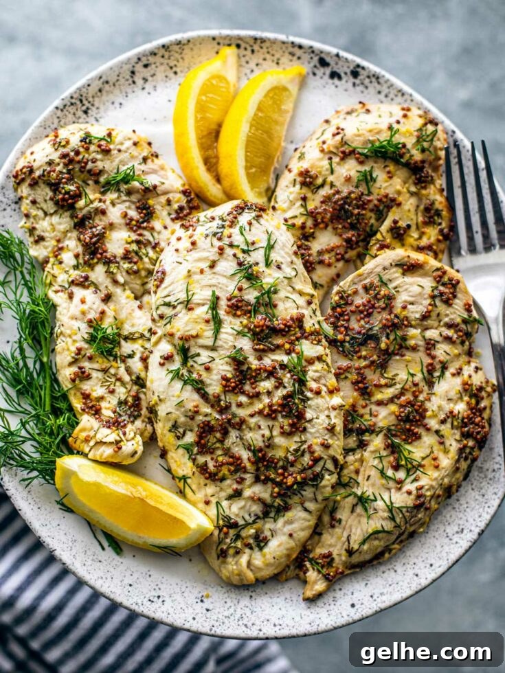 Air fryer chicken breasts with mustard sauce on plate.