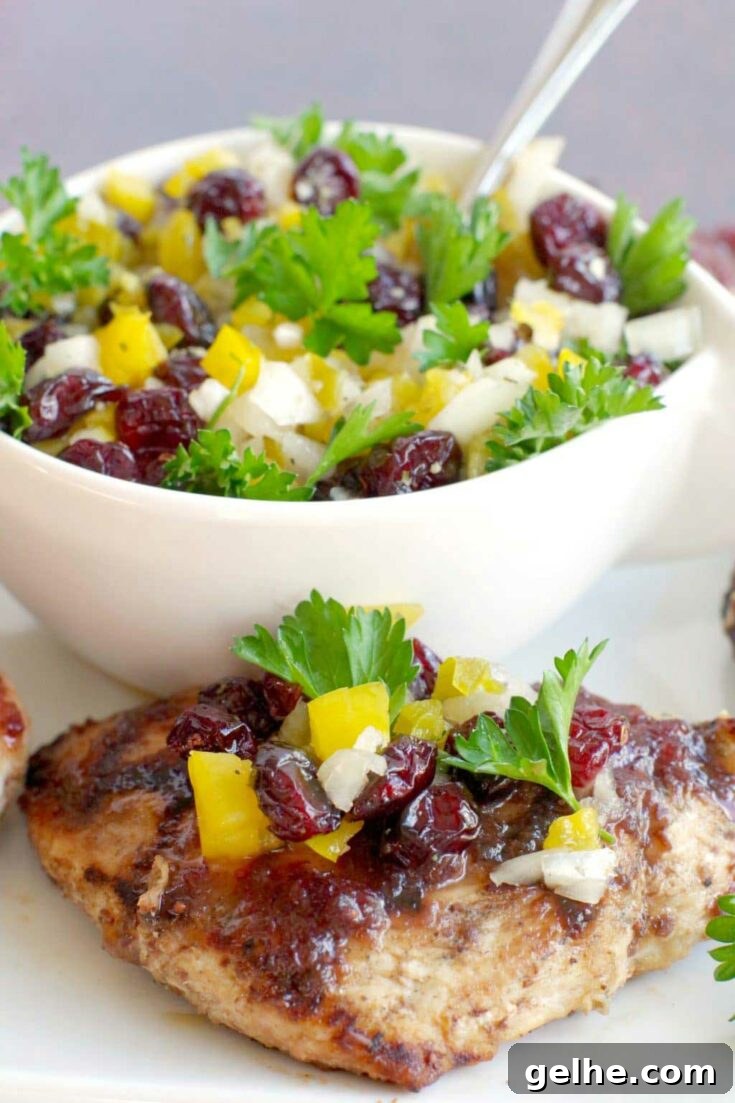 Grilled maple cranberry chicken with salsa on top.