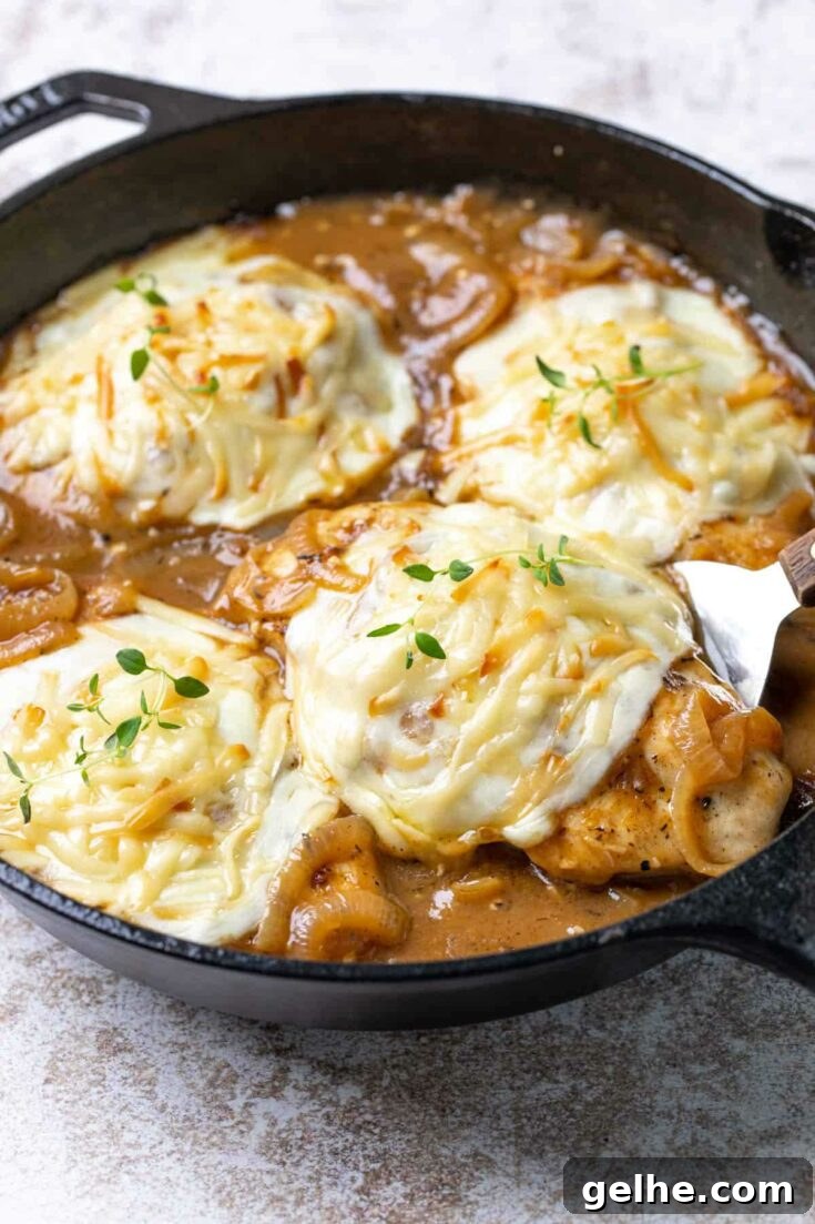 French onion chicken in cast iron skillet with melted cheese.