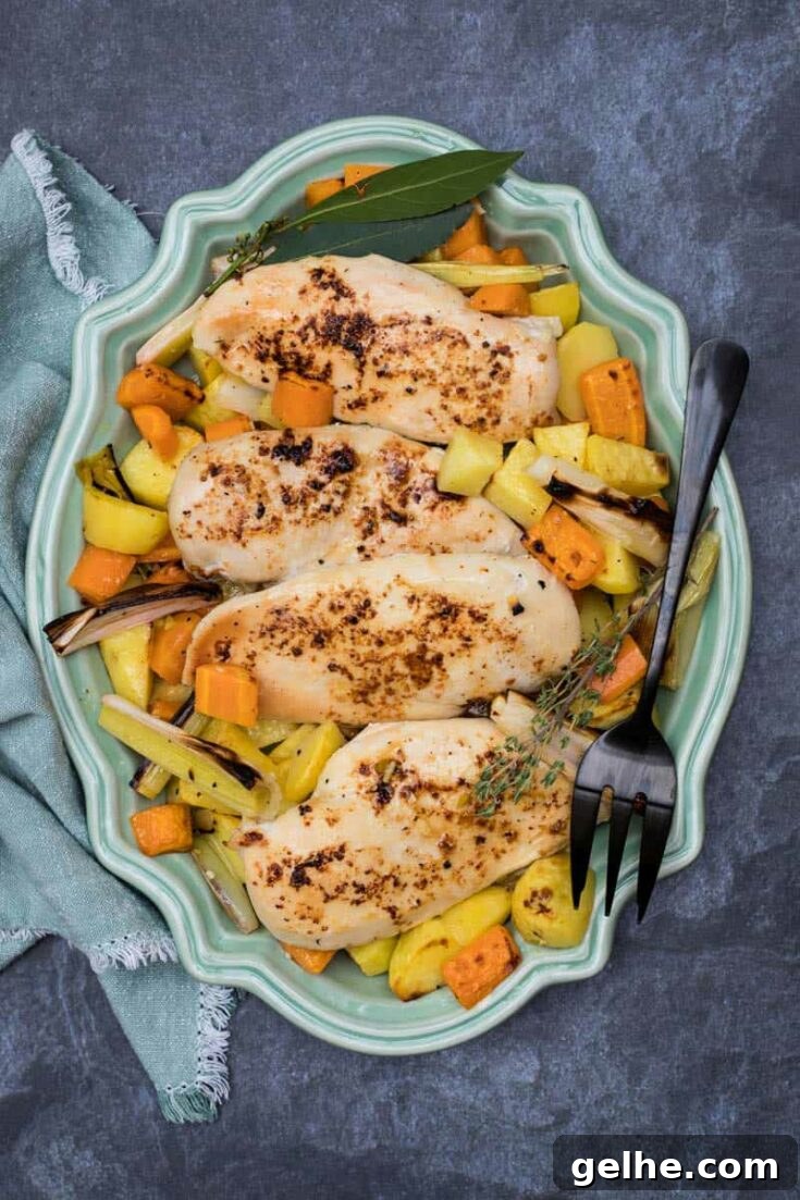 Sheet pan roasted chicken and potatoes arranged on platter.