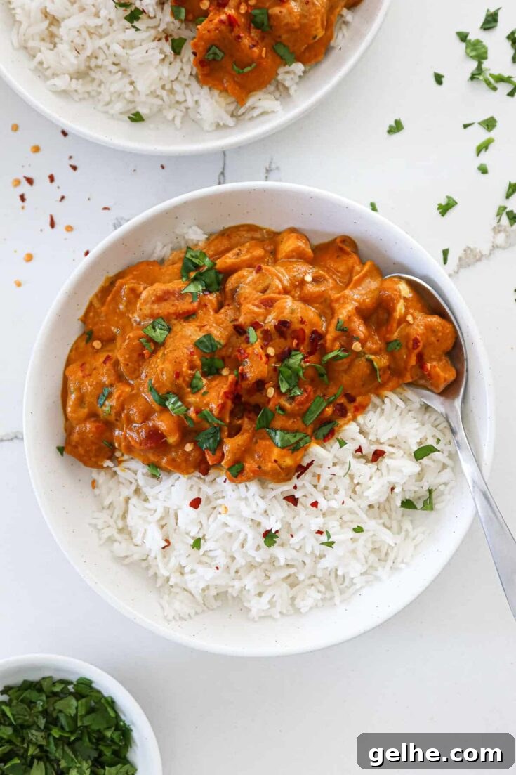 Pumpkin chicken curry served with rice in bowls.