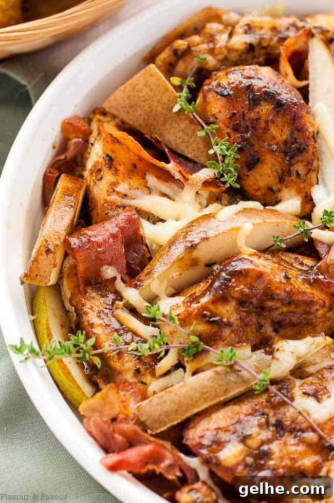 Closeup of serving dish with finished chicken, garnished with thyme.