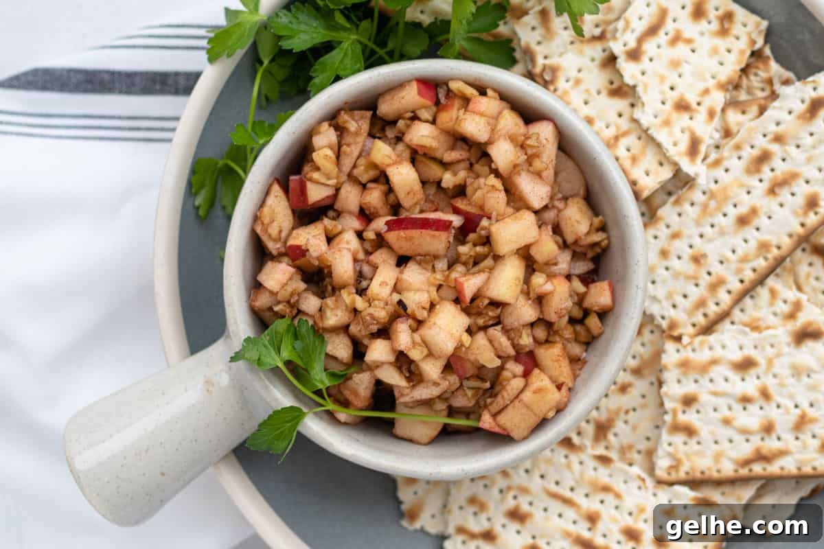 charoset in a bowl on a plate of matzo with parsley garnish
