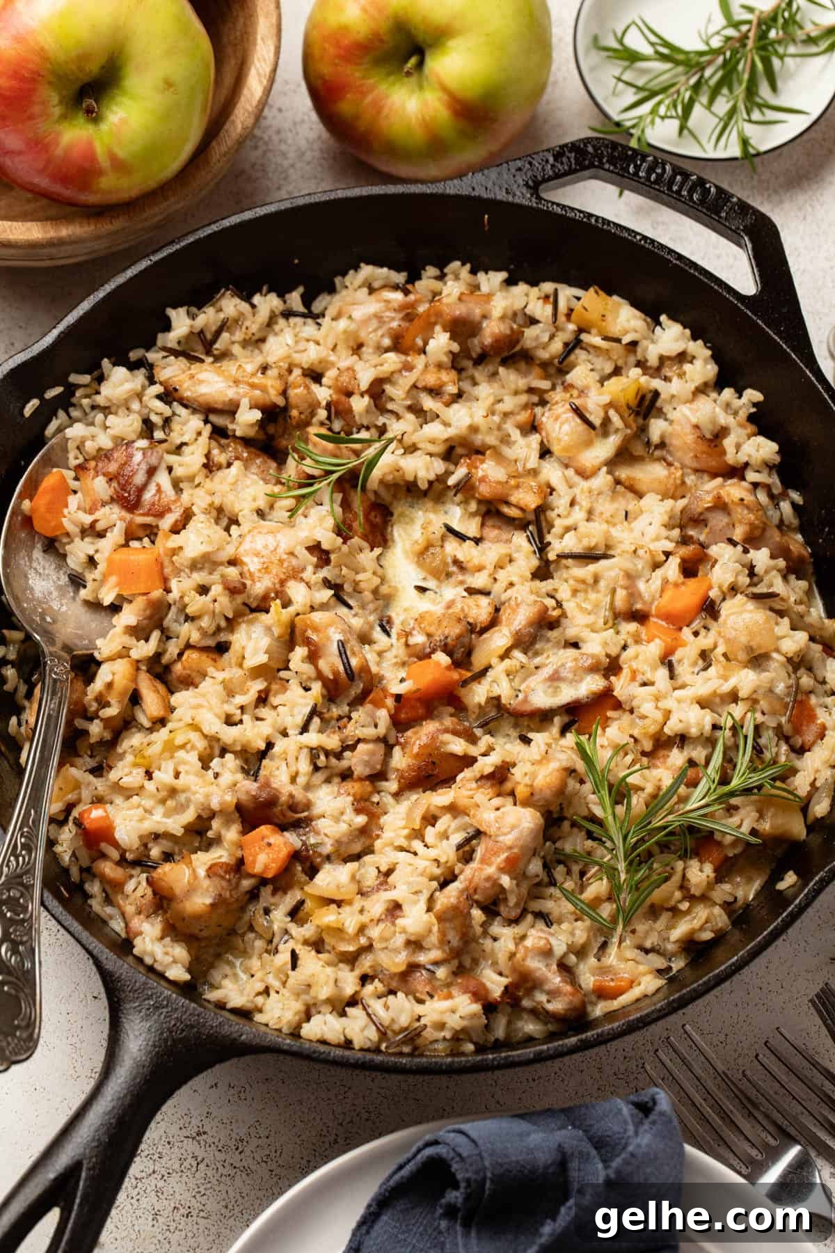 Dijon Chicken Skillet with Wild Rice and Creamy Mustard Sauce 2 Chicken and wild rice in a cast iron skillet with fresh rosemary on top.