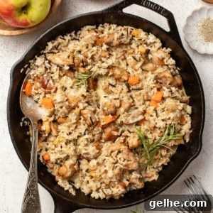 Dijon Chicken Skillet with Wild Rice and Creamy Mustard Sauce 11 A chicken and wild rice skillet with fresh herbs and vegetables on a white table.