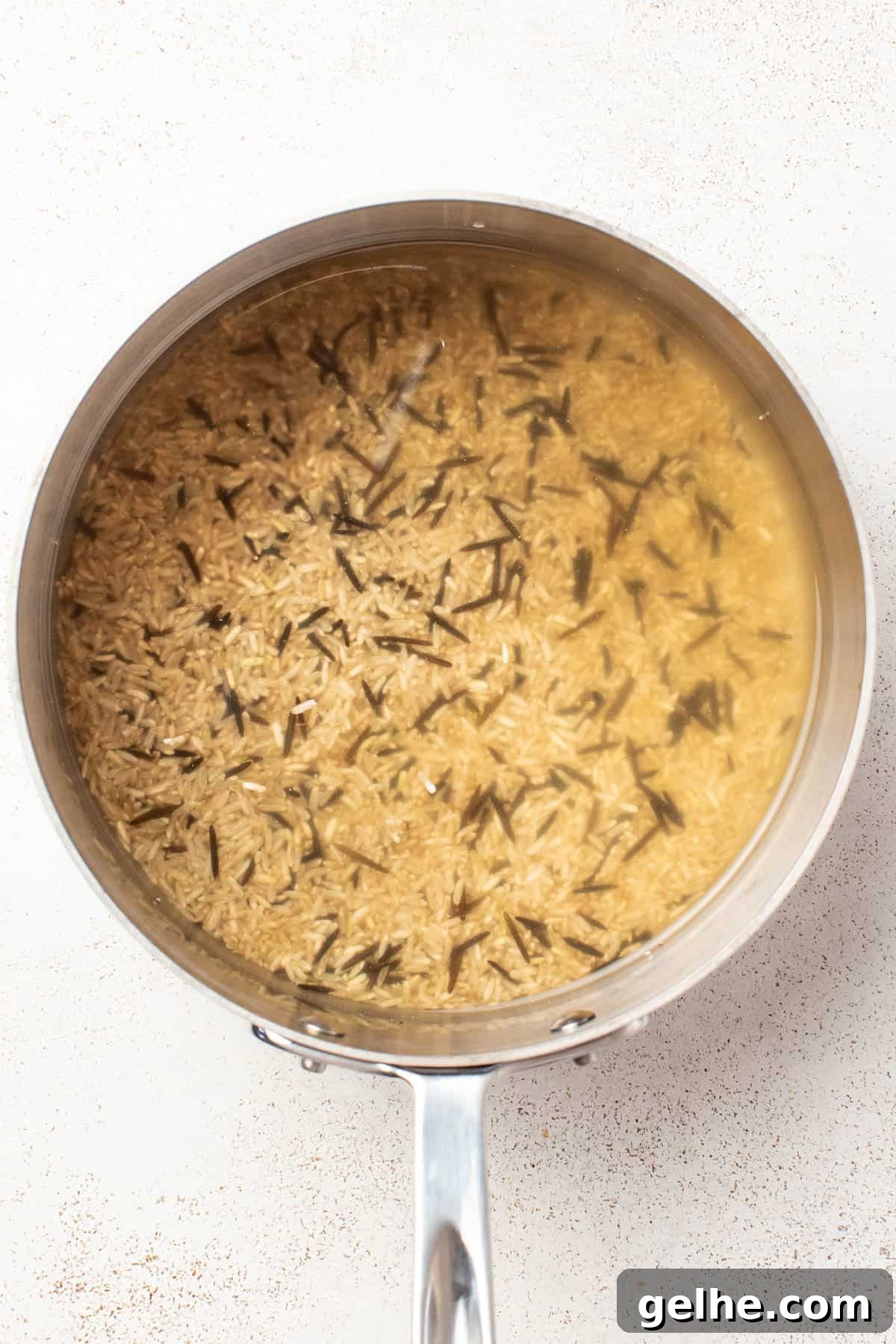 Dijon Chicken Skillet with Wild Rice and Creamy Mustard Sauce 4 Cooked wild rice blend in a pan.