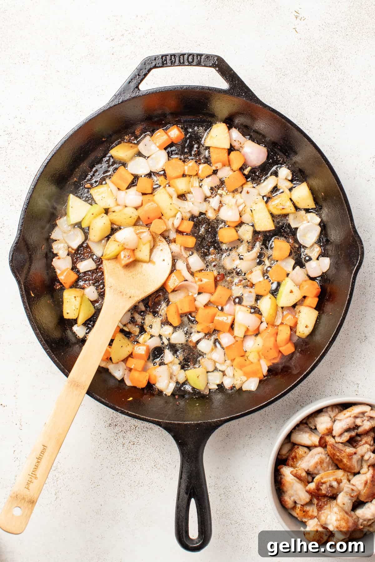 Dijon Chicken Skillet with Wild Rice and Creamy Mustard Sauce 6 Cooking carrots, apples, and shallots in a cast iron pan.