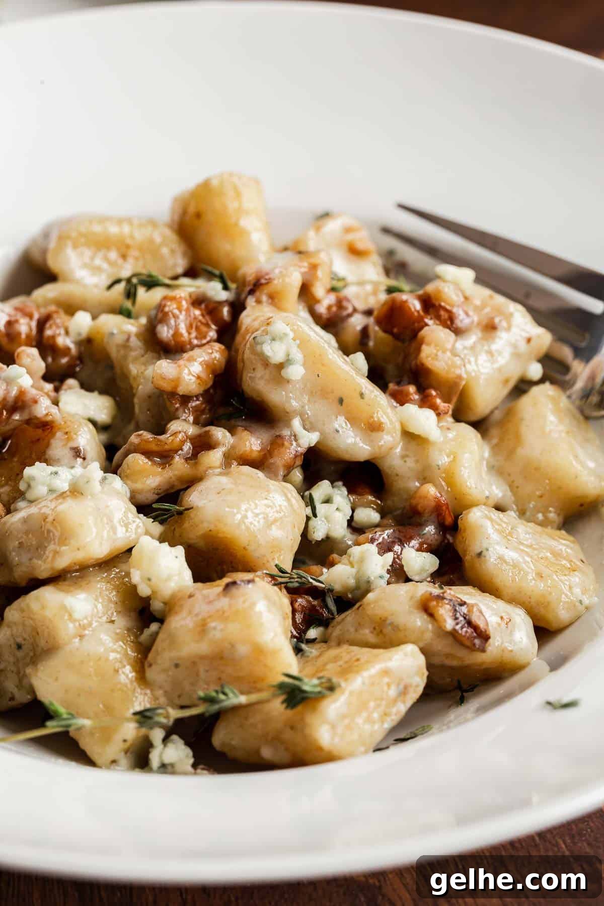 Close up of ricotta gnocchi in serving bowl.