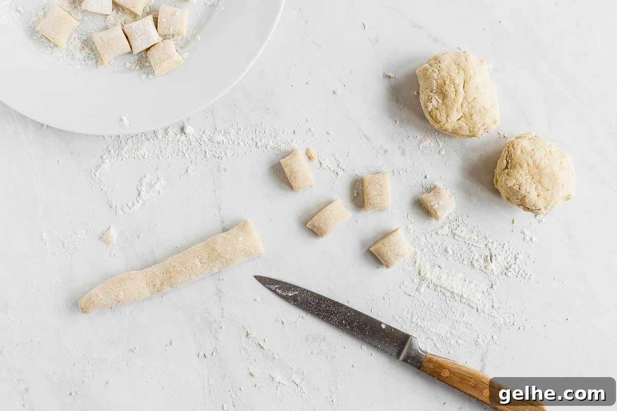 Raw gnocchi dough being rolled and cut into shapes.