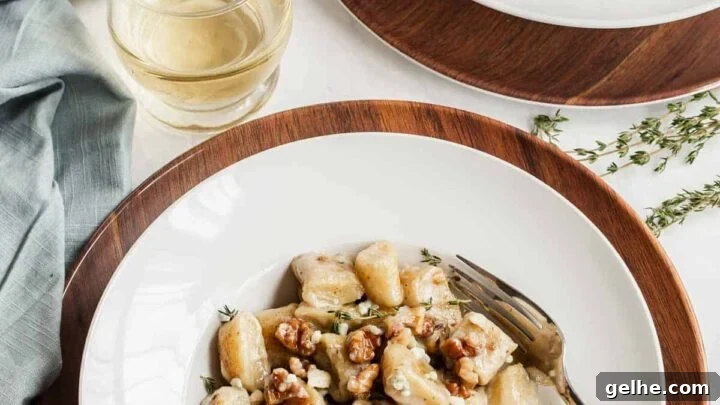 Two serving plates of ricotta gnocchi with white wine on the side.