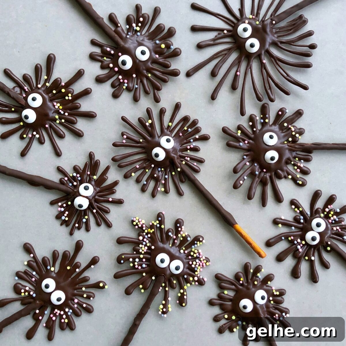 Chocolate pretzel treats with candy eyes and sprinkle decorations.