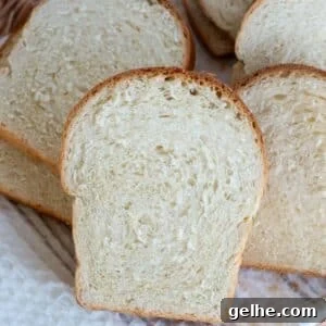 Slices of soft homemade sandwich bread showing a light and fluffy crumb.