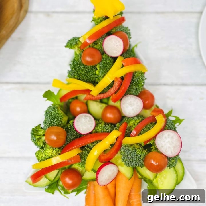 crudite Christmas tree platter - raw veg made into the shape of a christmas tree - includes broccoli, cucumber, carrots, celery, bell peppers, radish and tomatoes