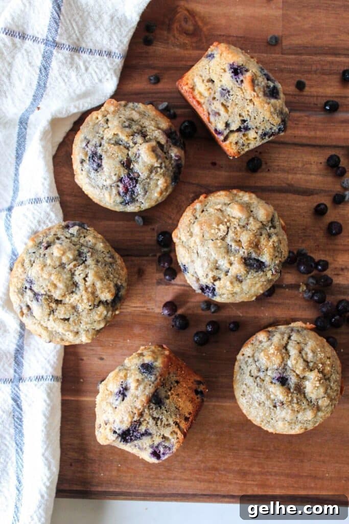 Blueberry chocolate chip muffins on a wooden board.