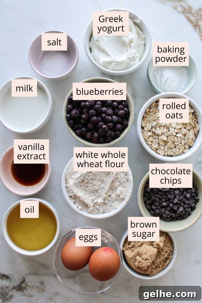 Ingredients for blueberry chocolate chip muffins on a countertop with labels.