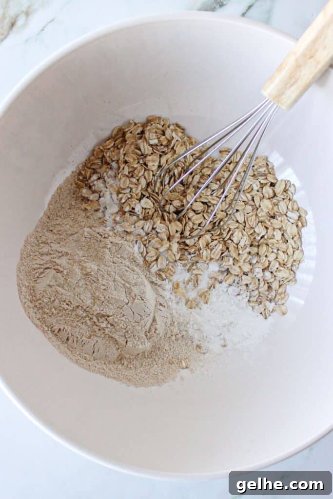 Dry ingredients for blueberry chocolate chip muffins in a bowl with a whisk.