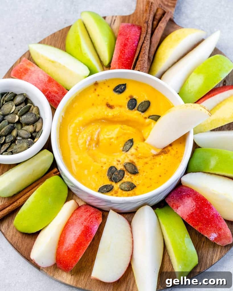 Apple slice in pumpkin dip.