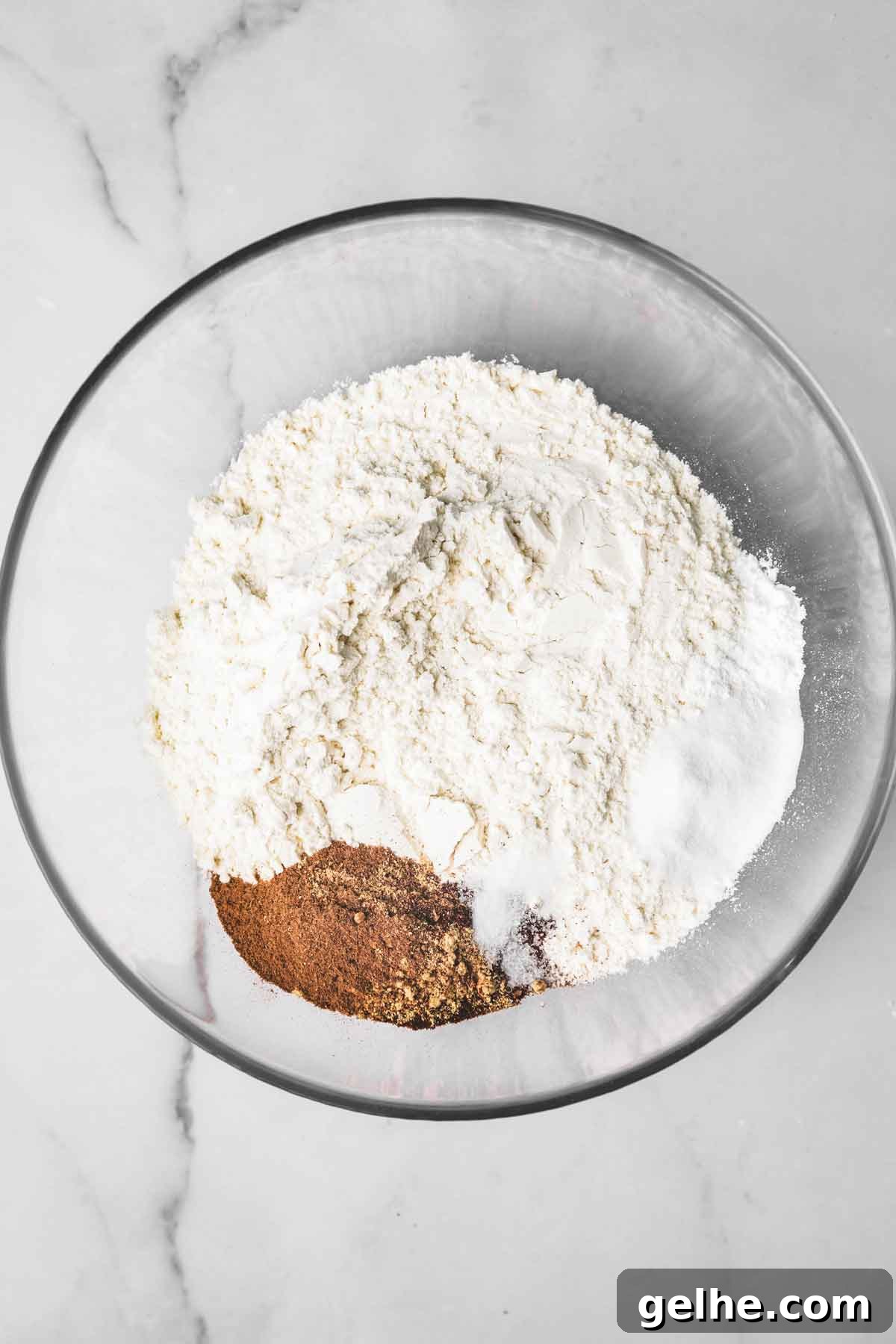 Frosted Gingerbread Cookies Recipe for Holiday Baking 4 medium bowl with flour mixture and gingerbread spices