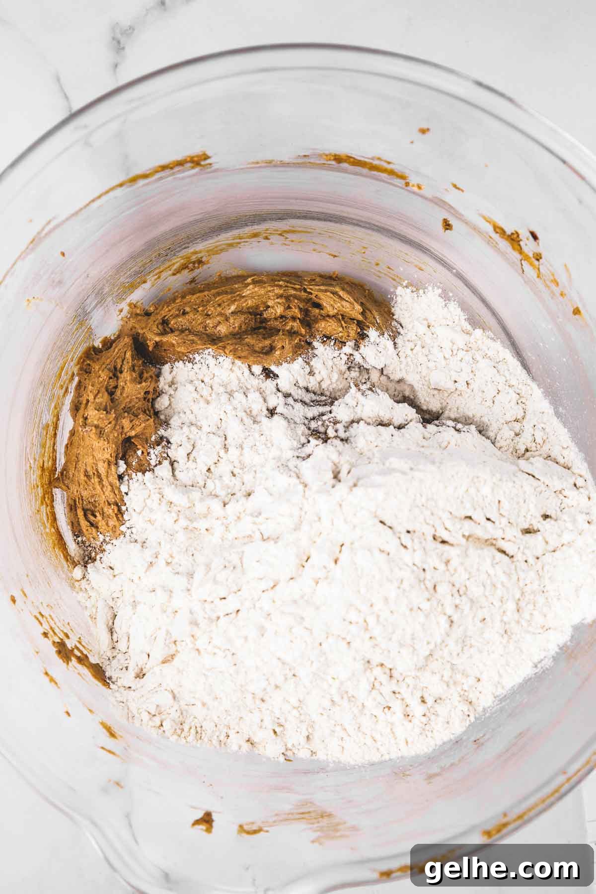 Frosted Gingerbread Cookies Recipe for Holiday Baking 7 large mixing bowl with gingerbread cookie batter and dry ingredients