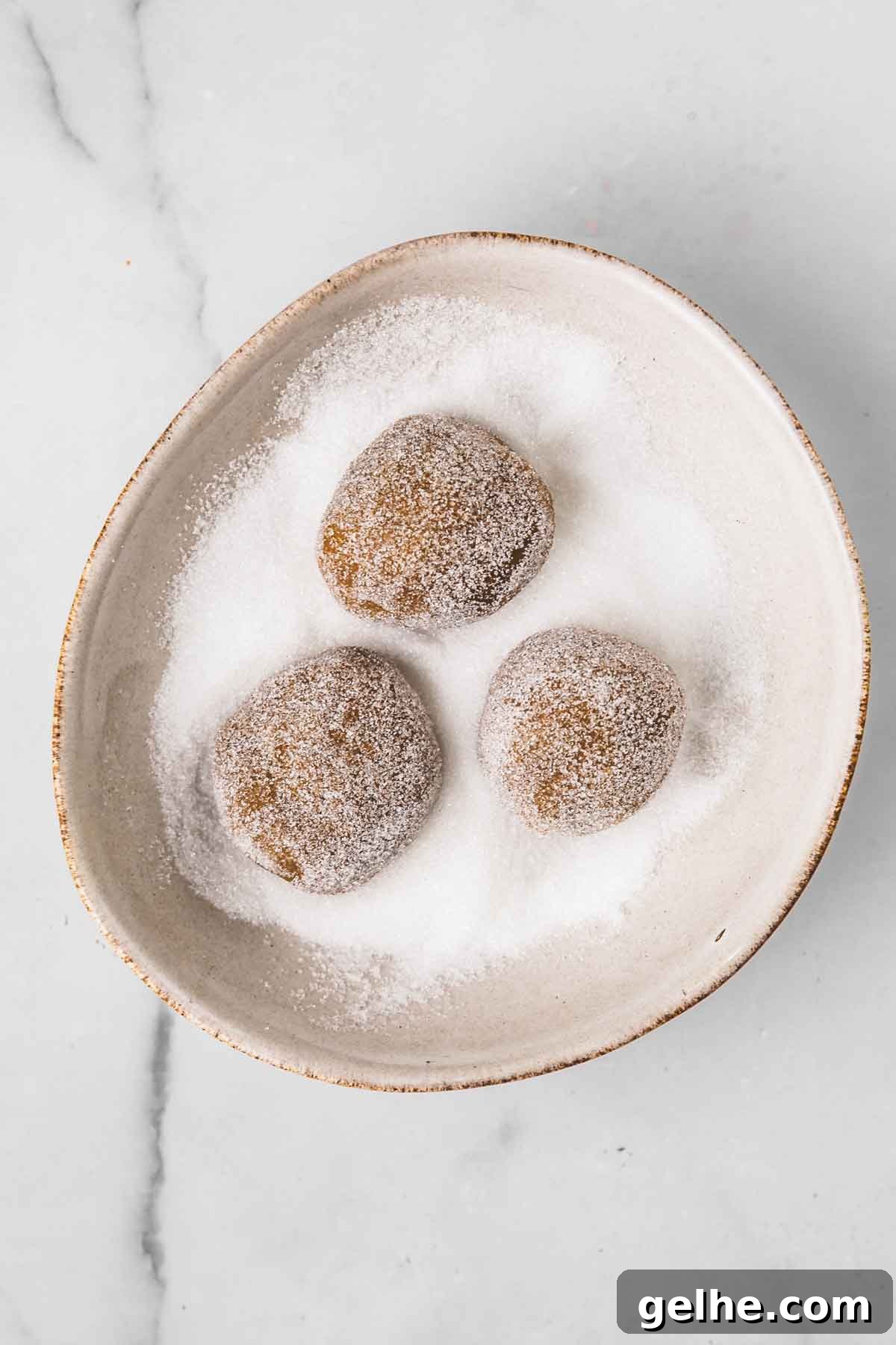 Frosted Gingerbread Cookies Recipe for Holiday Baking 9 medium bowl with sugar and gingerbread cookie dough balls