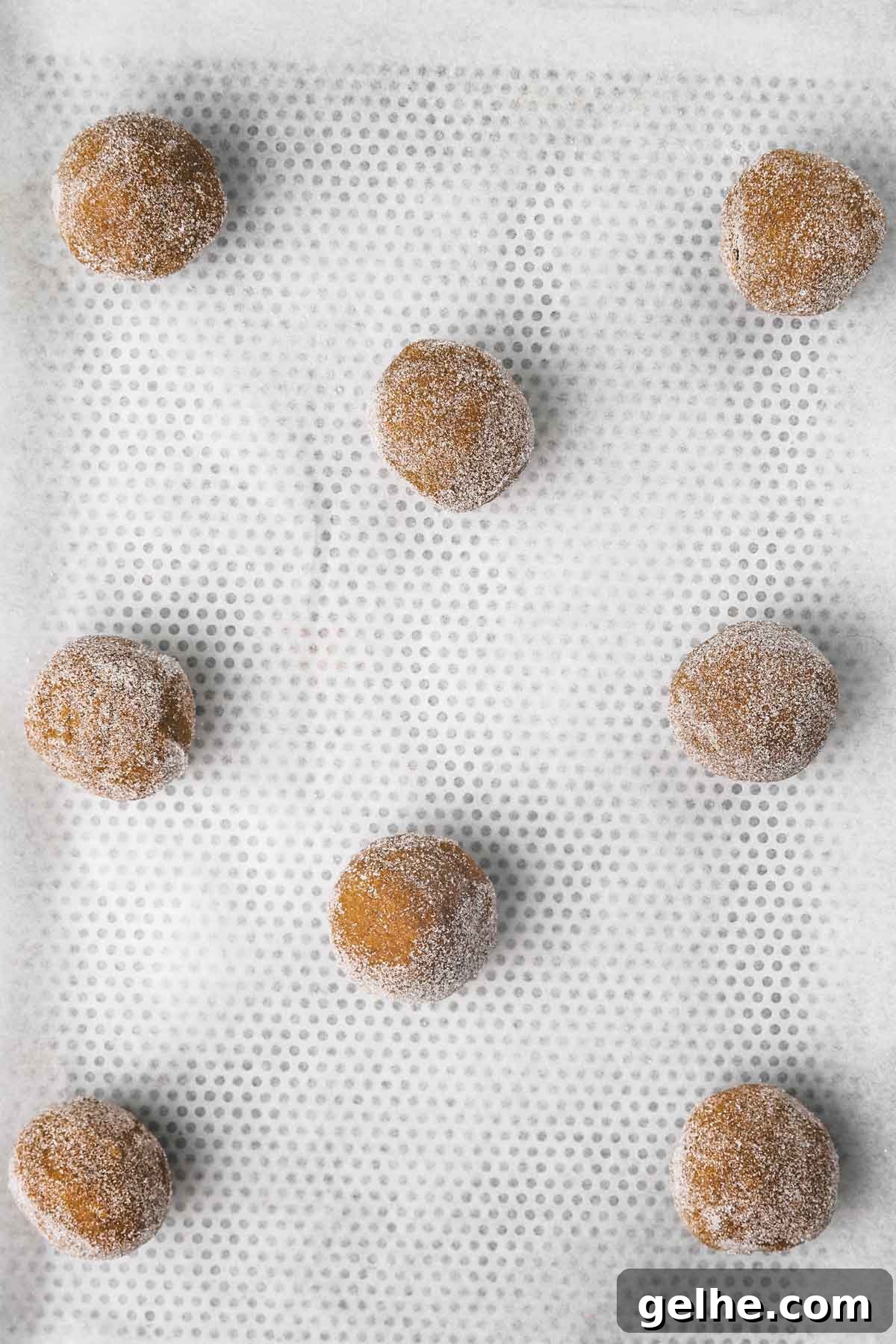 Frosted Gingerbread Cookies Recipe for Holiday Baking 10 gingerbread cookie dough balls on a cookie sheet
