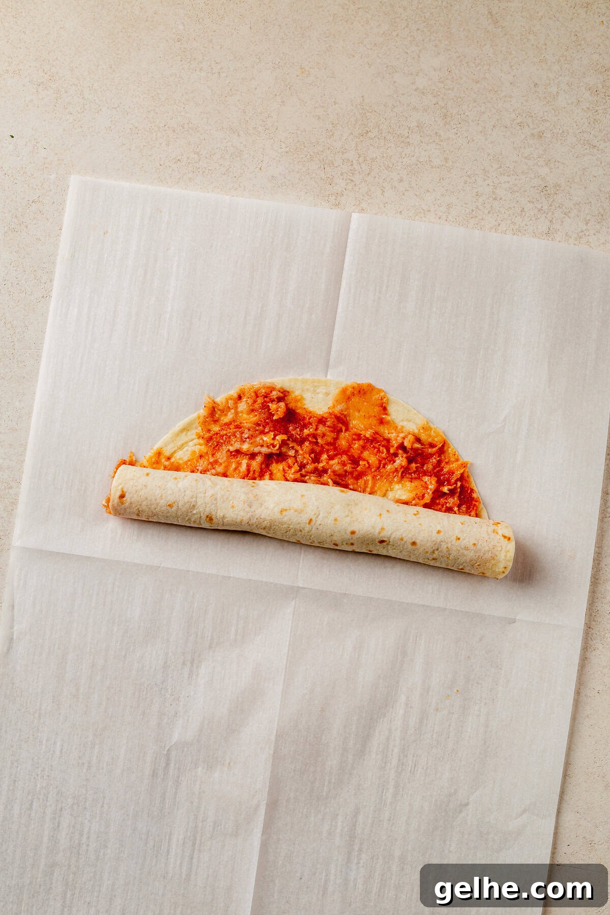 rolling a lazy kebab tortilla with ground chicken.