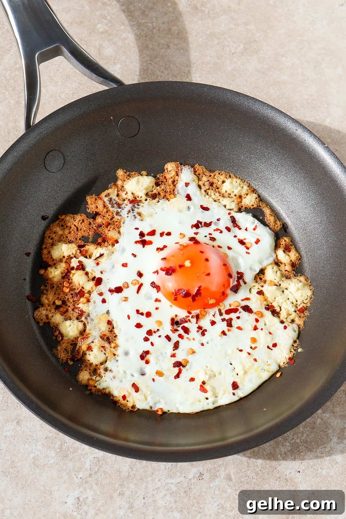 Crispy feta fried egg in a skillet.