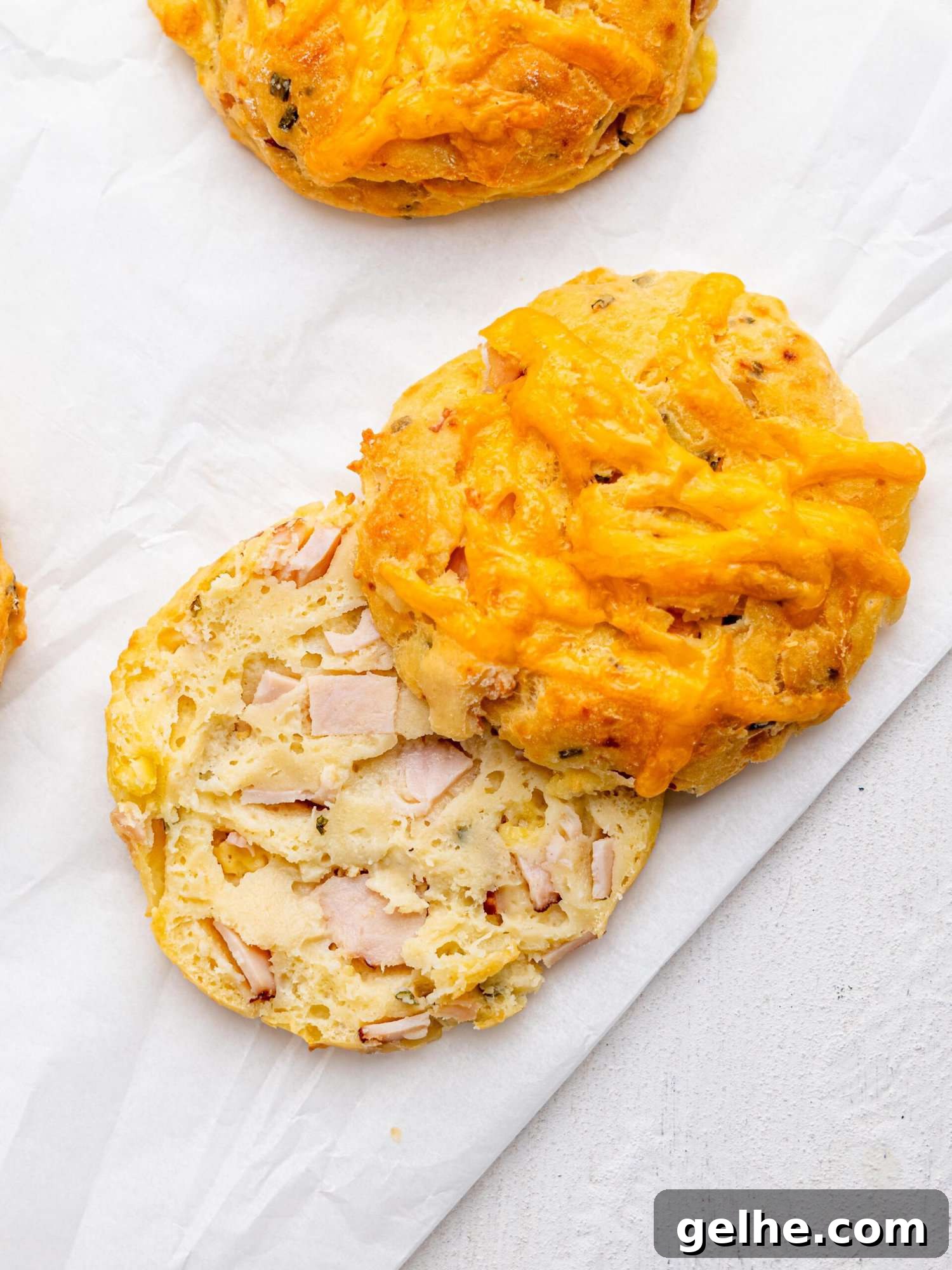 High-Protein Biscuits Without Butter – Fluffy, Low-Fat Recipe 3 Bird's eye view of a ham and cheese biscuit cut in half.