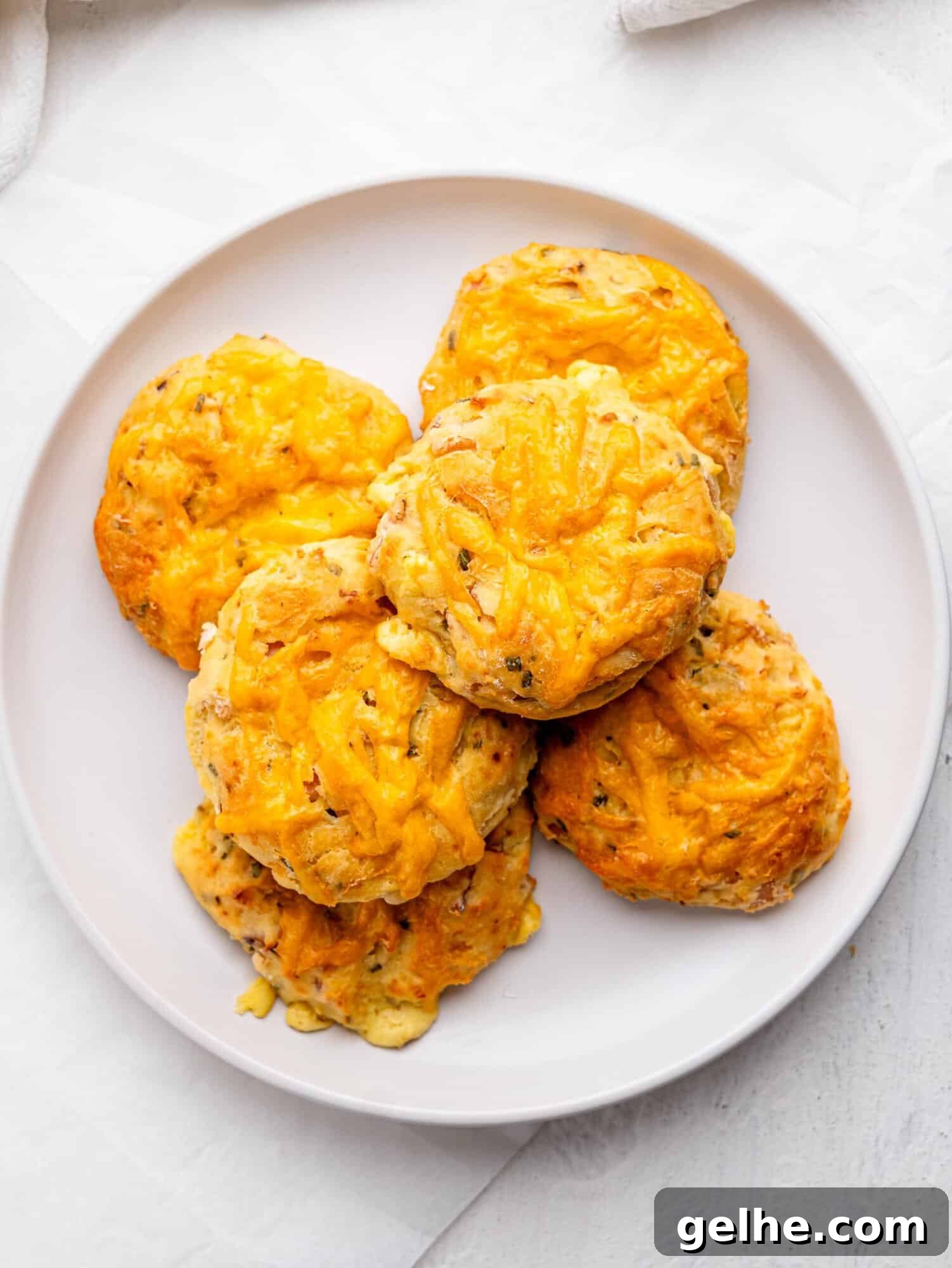 High-Protein Biscuits Without Butter – Fluffy, Low-Fat Recipe 5 Bird's eye view of six protein bagels on a white plate.