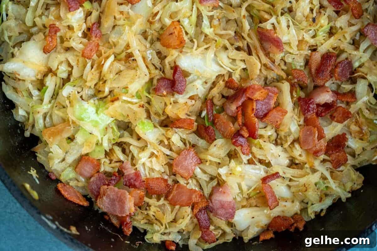 horizontal image showing crispy bacon mixed with fried shredded cabbage
