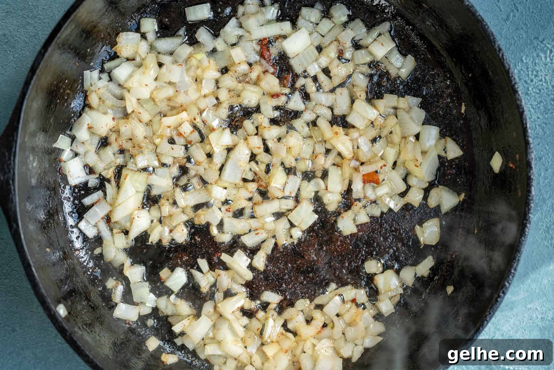 diced onion softening in a pan