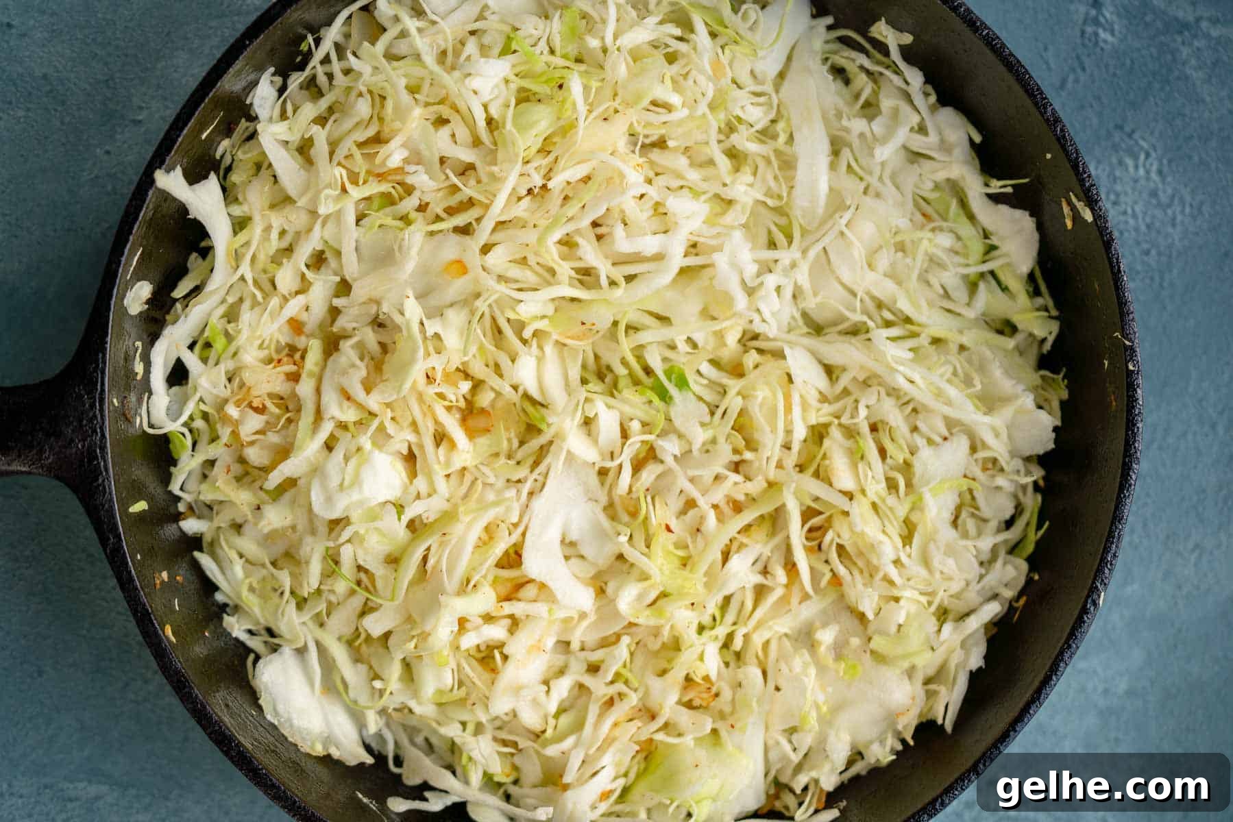 shredded cabbage dumped into a skillet